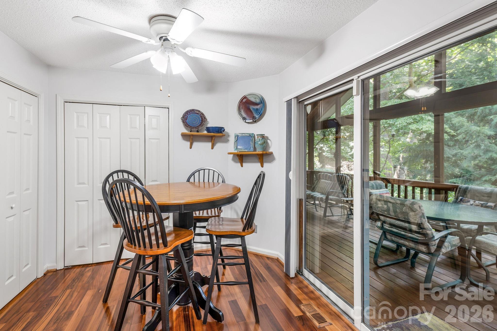 The screen porch is just off the kitchen area. Perfect location for dining and entertaining al fresco. - 31 Hillcreek Drive, Asheville