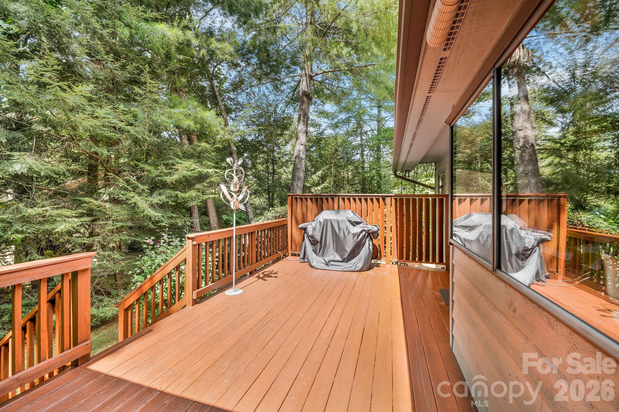 Freshly stained back deck with stairs to the back yard. - 31 Hillcreek Drive, Asheville