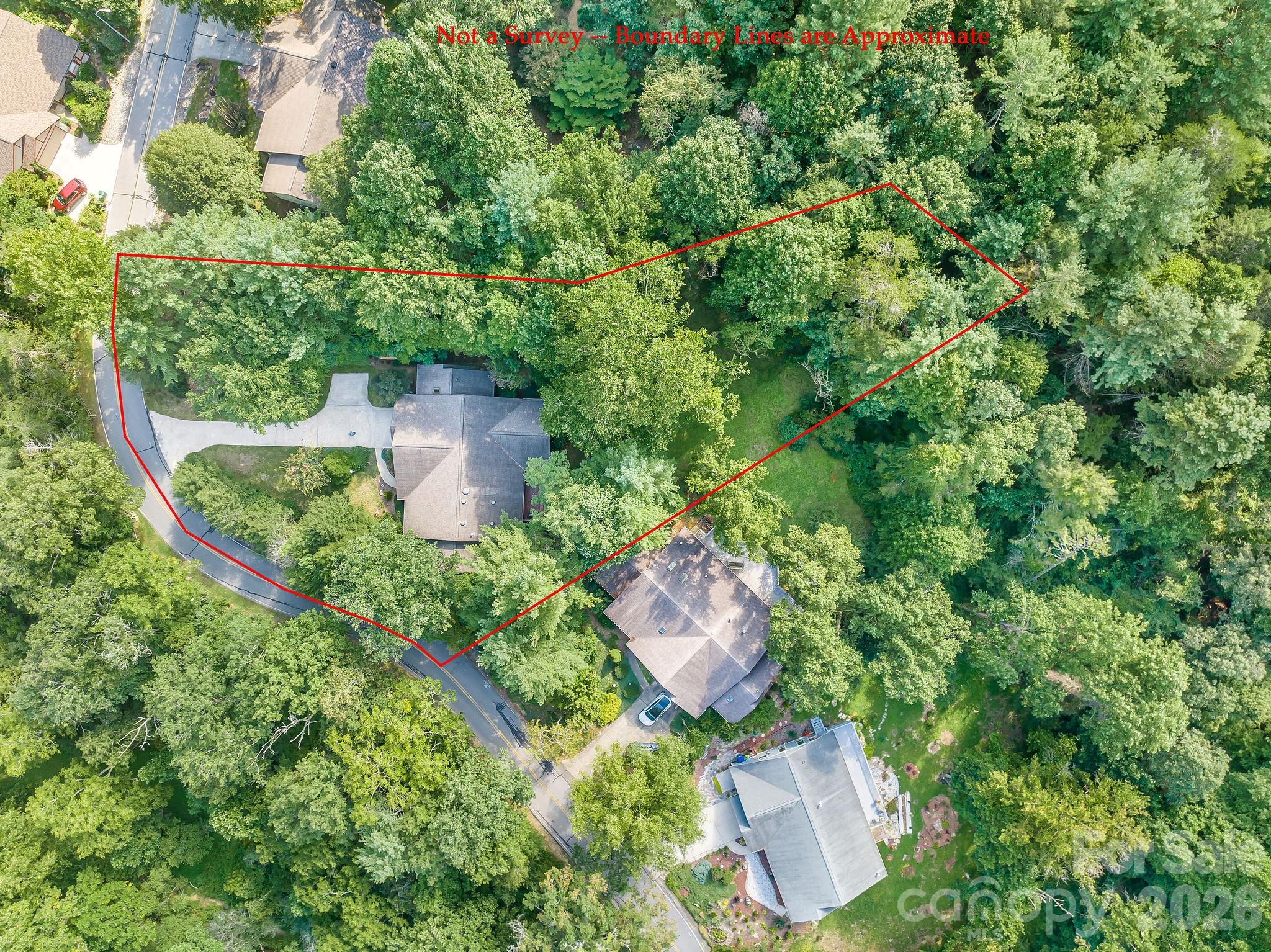 The .74 acre lot is flat and includes an open back area - like a tree house with a glen. - 31 Hillcreek Drive, Asheville