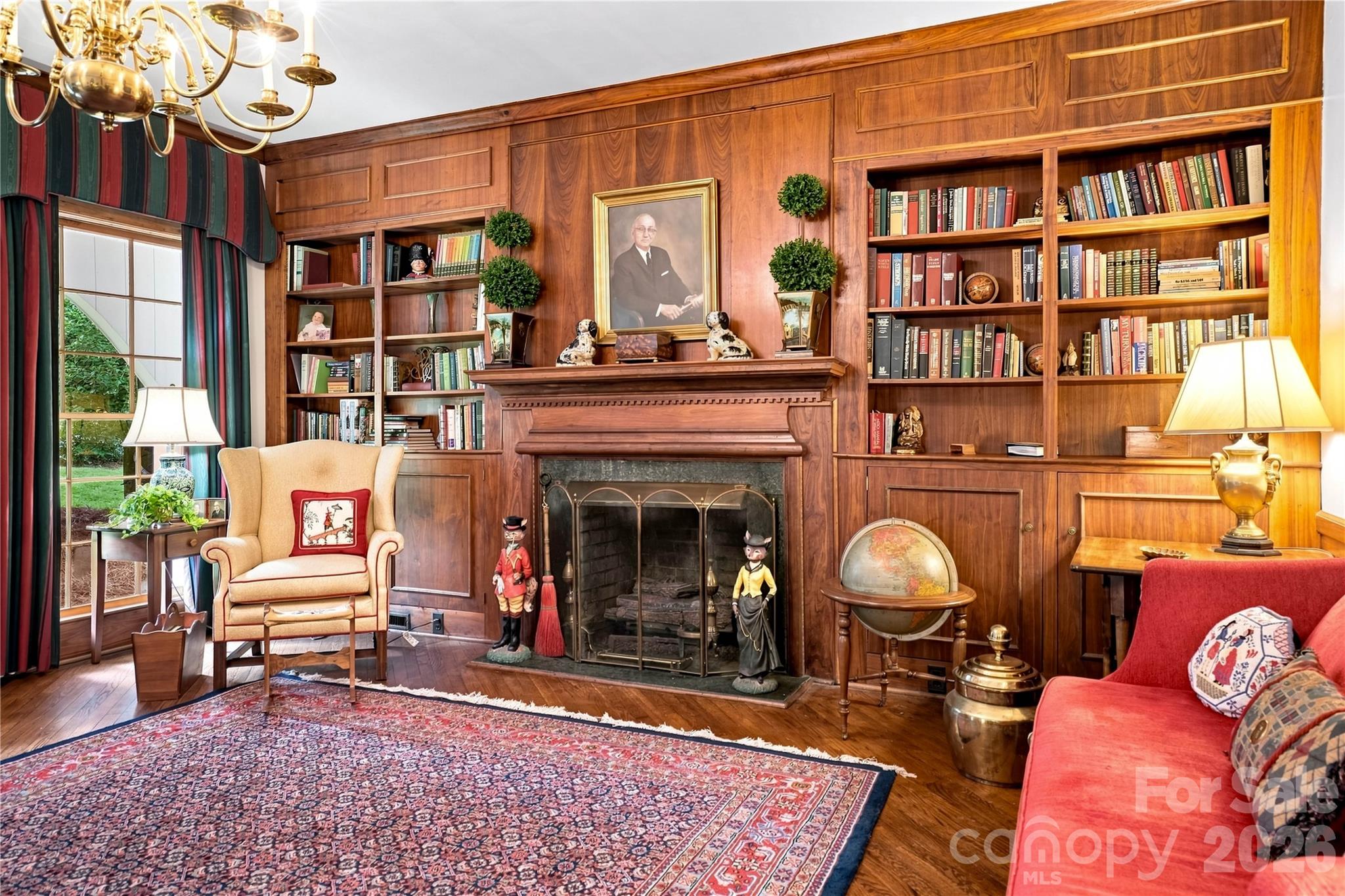 Wood-paneled family room with built-in bookcases and gas fireplace. - 209 Labans Lane, Lincolnton