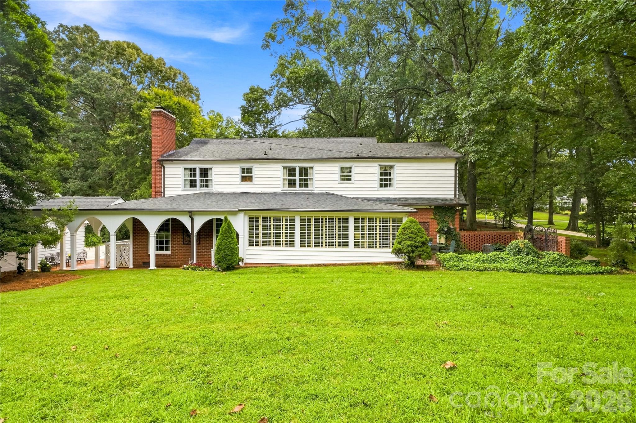 Rear exterior view across the expansive lawn. - 209 Labans Lane, Lincolnton