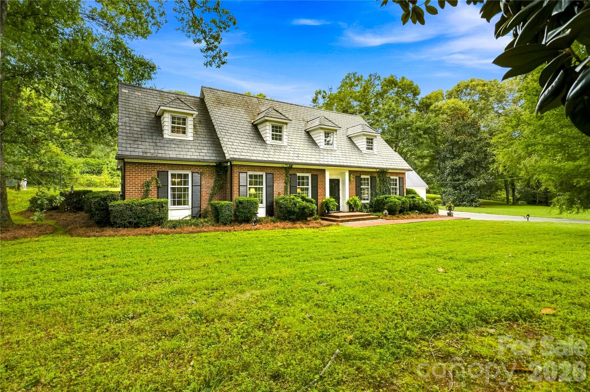 Classic front exterior with slate roof and dormer windows. - 209 Labans Lane, Lincolnton