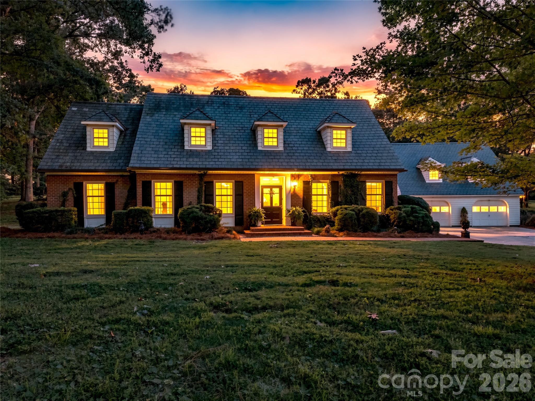 Twilight exterior highlighting the home’s timeless presence. - 209 Labans Lane, Lincolnton