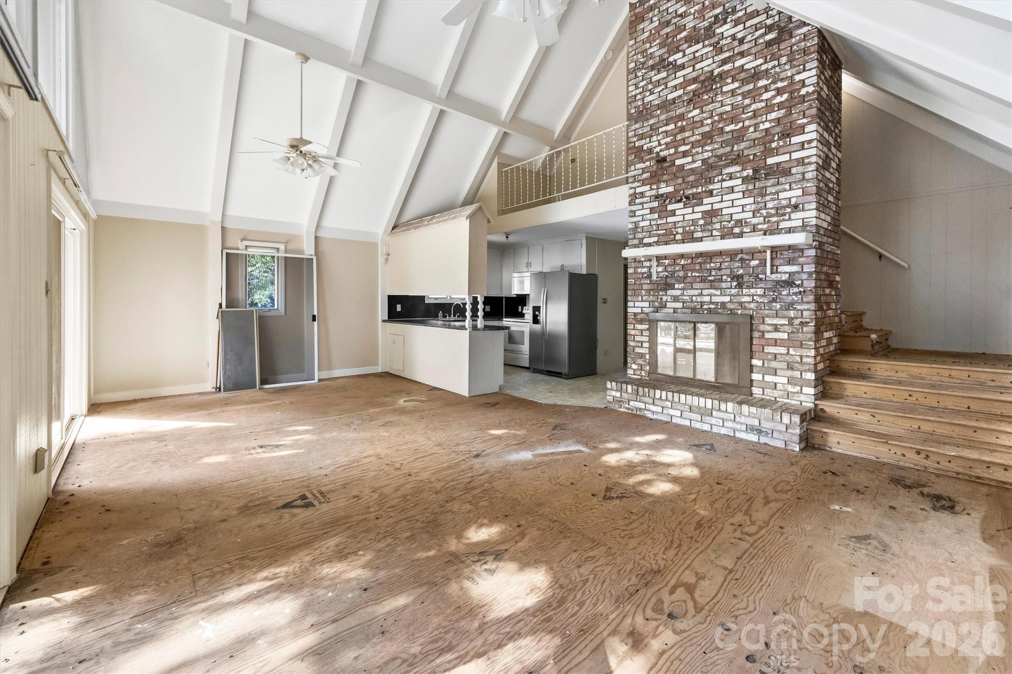 Great room with tons of natural light and wood burning fireplace - 131 Baywatch Drive, Mooresville