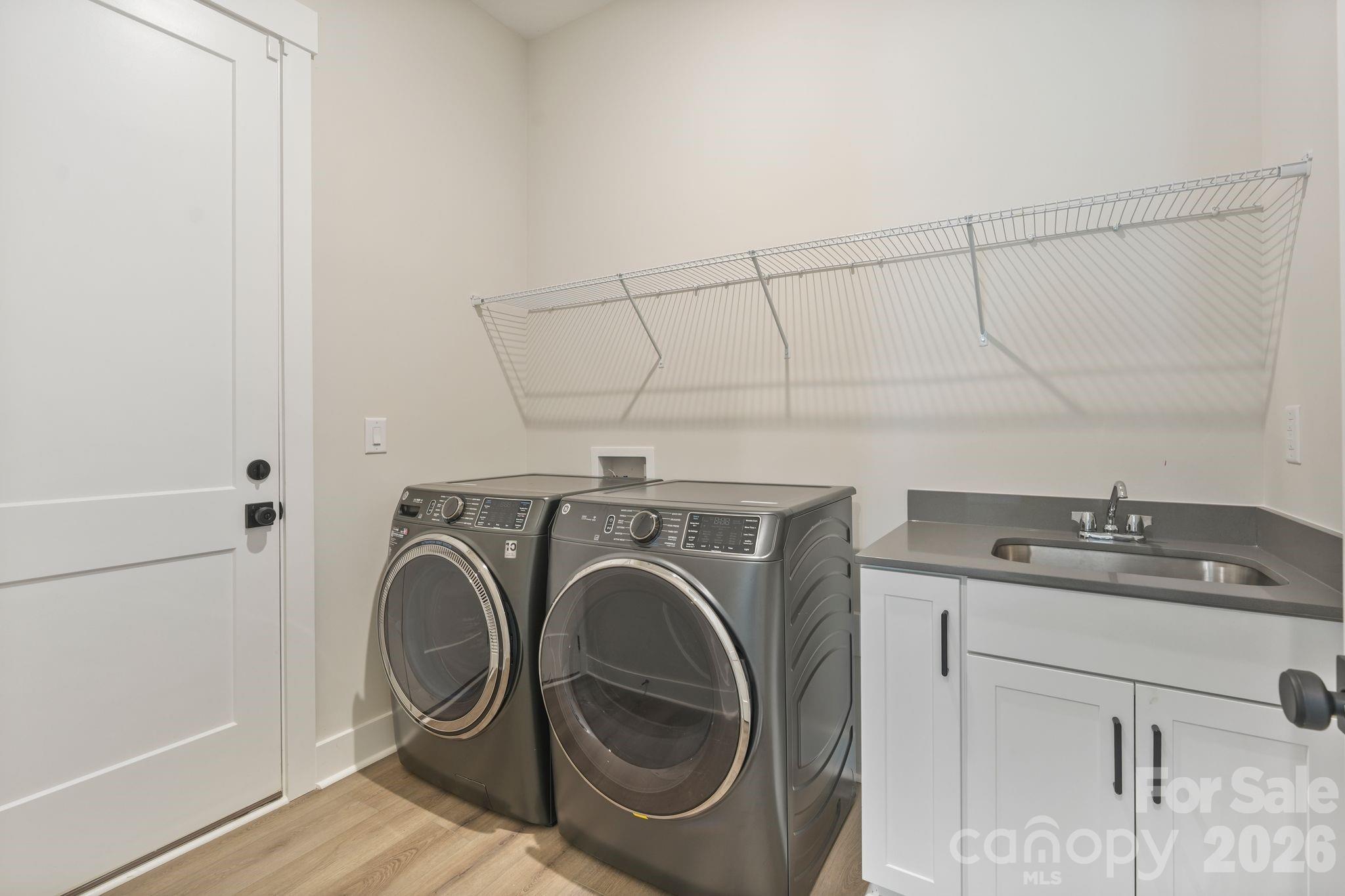 Spacious laundry room includes washer, dryer, and utility sink - 4531 Splash Trail, Sherrills Ford