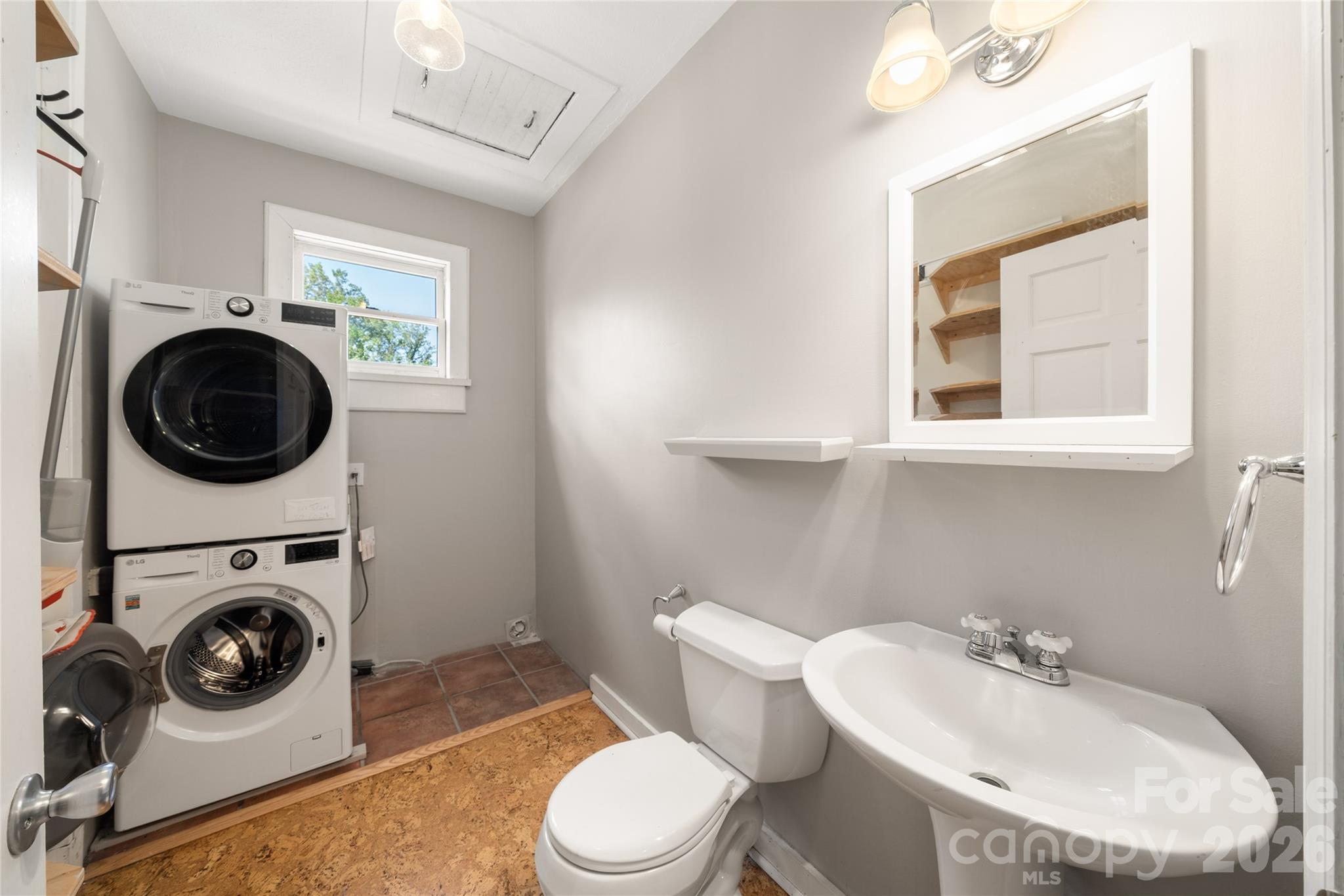 Laundry/half bath combination with attic storage space above - 101 Olney Road, Asheville
