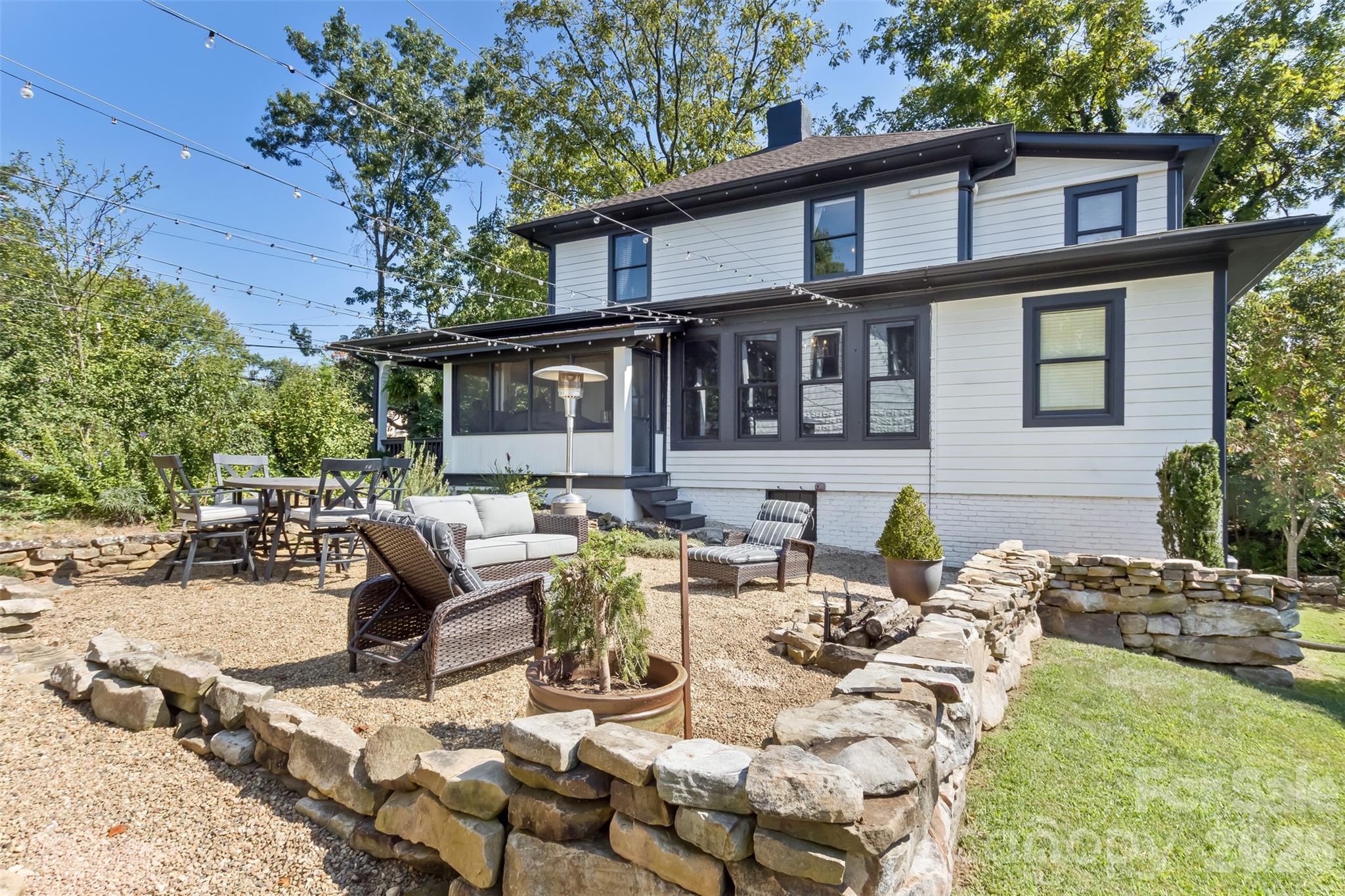 Side view of home with firepit and sitting area - 293 Fairview Road, Asheville