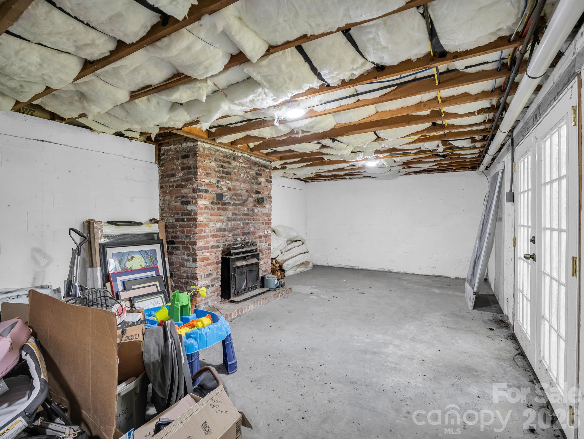 Versatile basement space has a fireplace and french doors leading to the back yard - 3208 Florida Drive, Hendersonville
