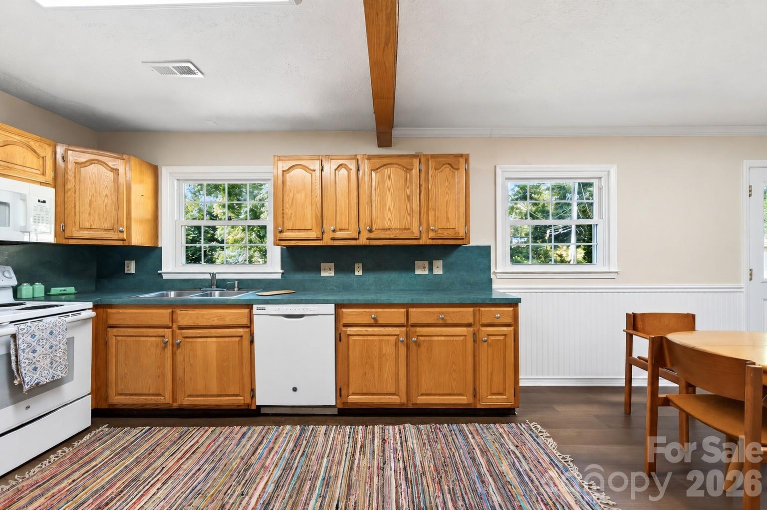 New laminate flooring in the kitchen (NOTE: ONE CABINET DOOR IS MISSING AND IN THE PROCESS OF BEING REPLACED...PHOTO EDITED TO INCLUDE DOOR) - 2 Independence Boulevard, Asheville