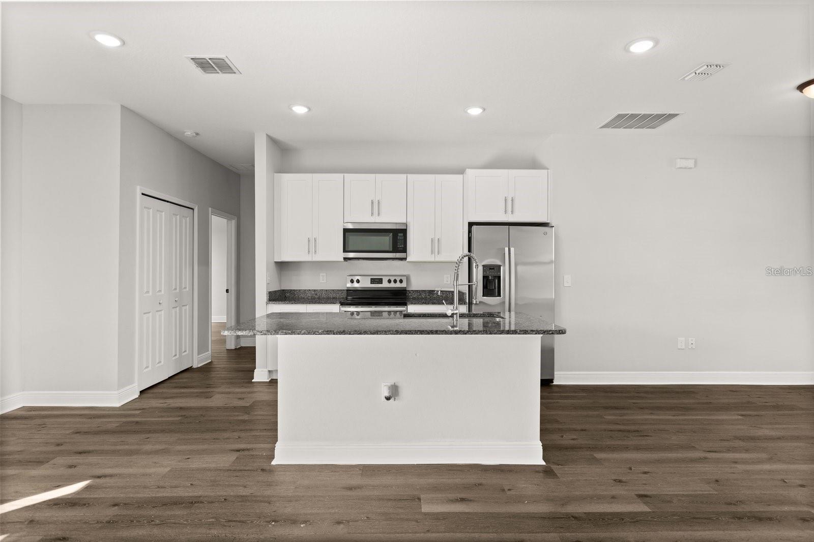 Kitchen comes with stainless steel appliances and an island - 1101 SAINT TROPEZ CT, KISSIMMEE