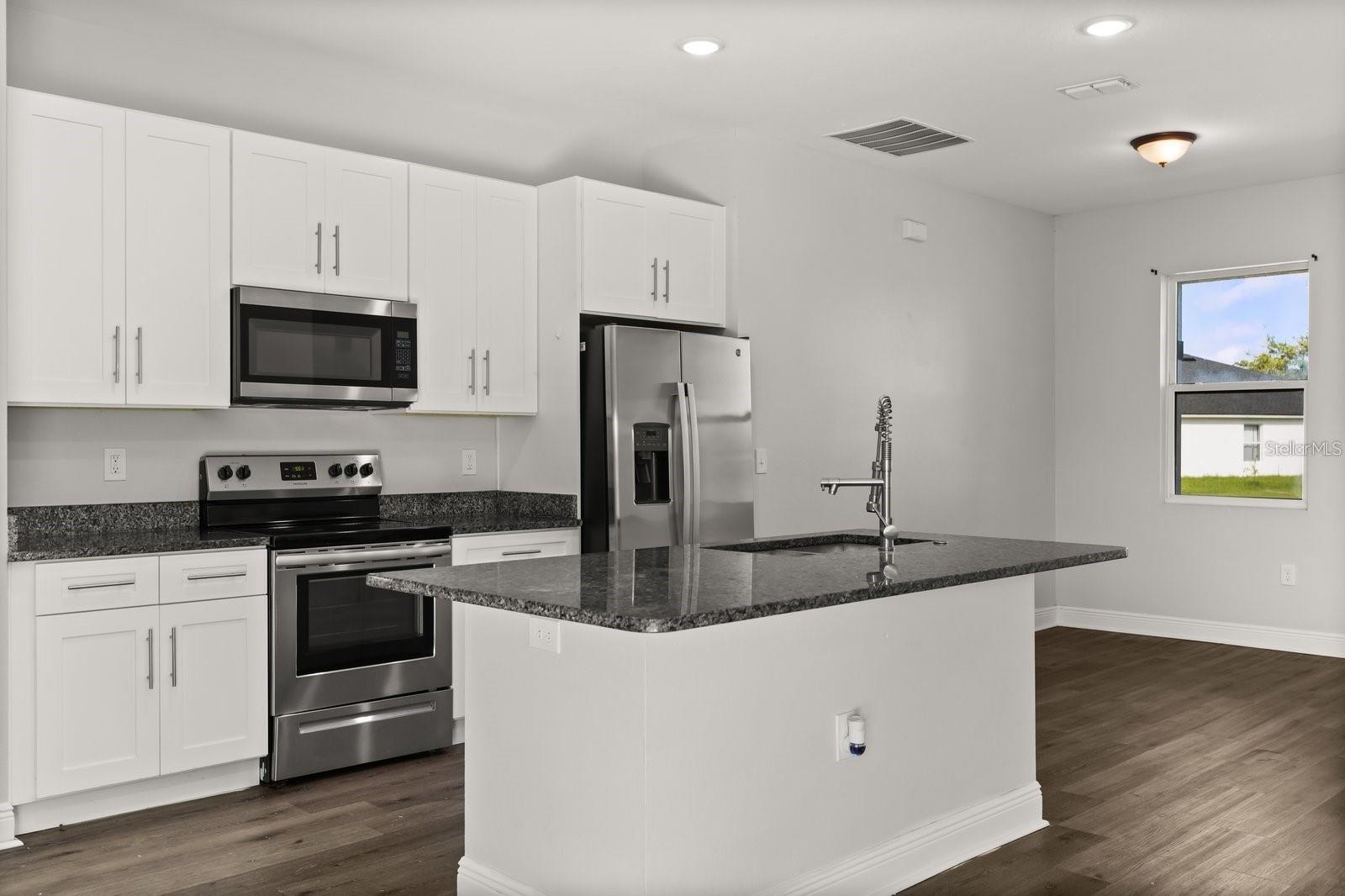 Kitchen comes with stainless steel appliances and an island - 1125 MUNSTER CT, KISSIMMEE