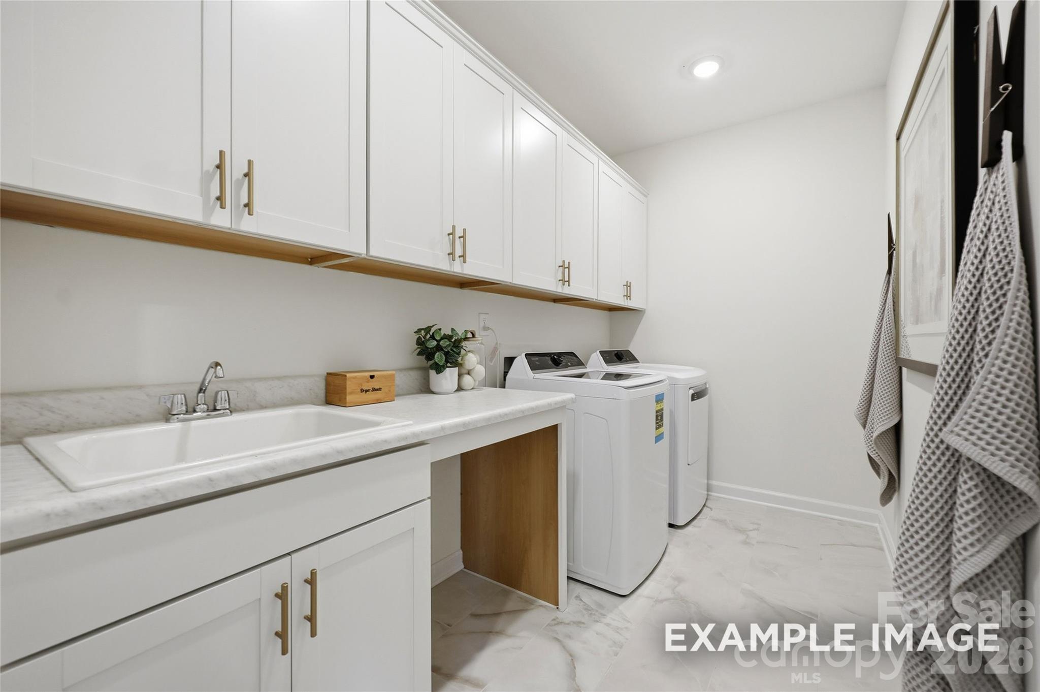 sample laundry room photo with drop in sink & cabinets - 2919 Audubon Ridge Drive, Belmont