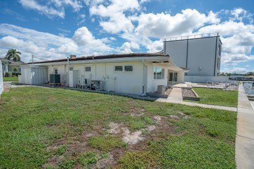 The spacious waterfront lot offers an abundance of room to swim, boat, relax, and entertain, complemented by a generously sized side yard and an exceptional setting for enjoying the Florida lifestyle. - 6505 DEBBIE LN S, ST PETERSBURG