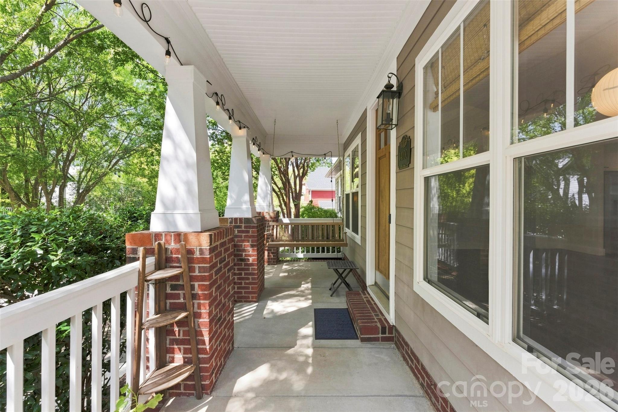 Classic covered front porch with bench swing - 14100 Garden District Row, Huntersville