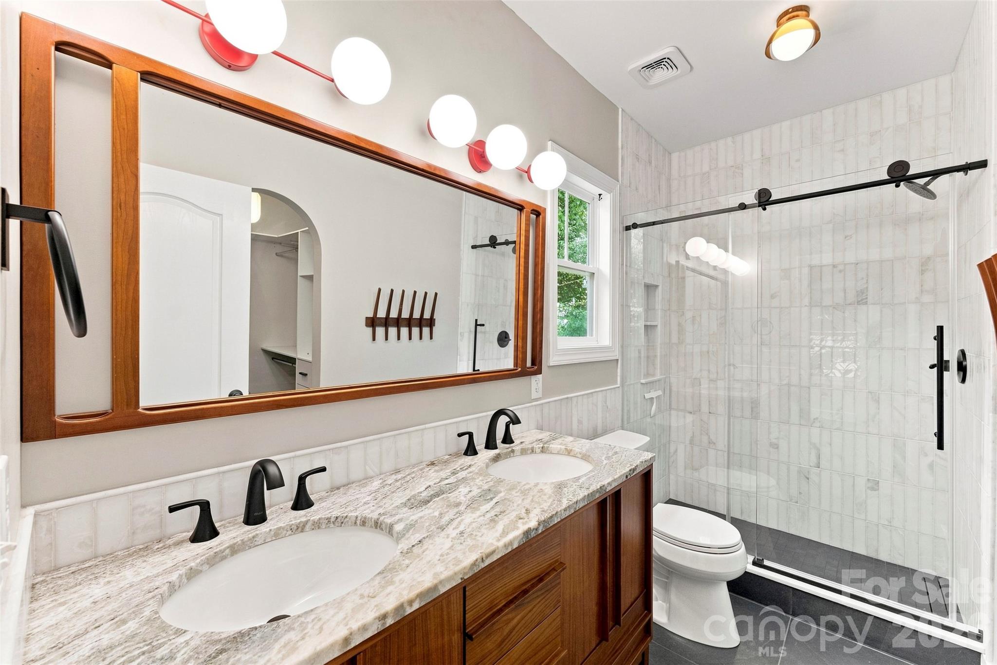Renovated primary bath with dual vanity and tiled shower - 14100 Garden District Row, Huntersville