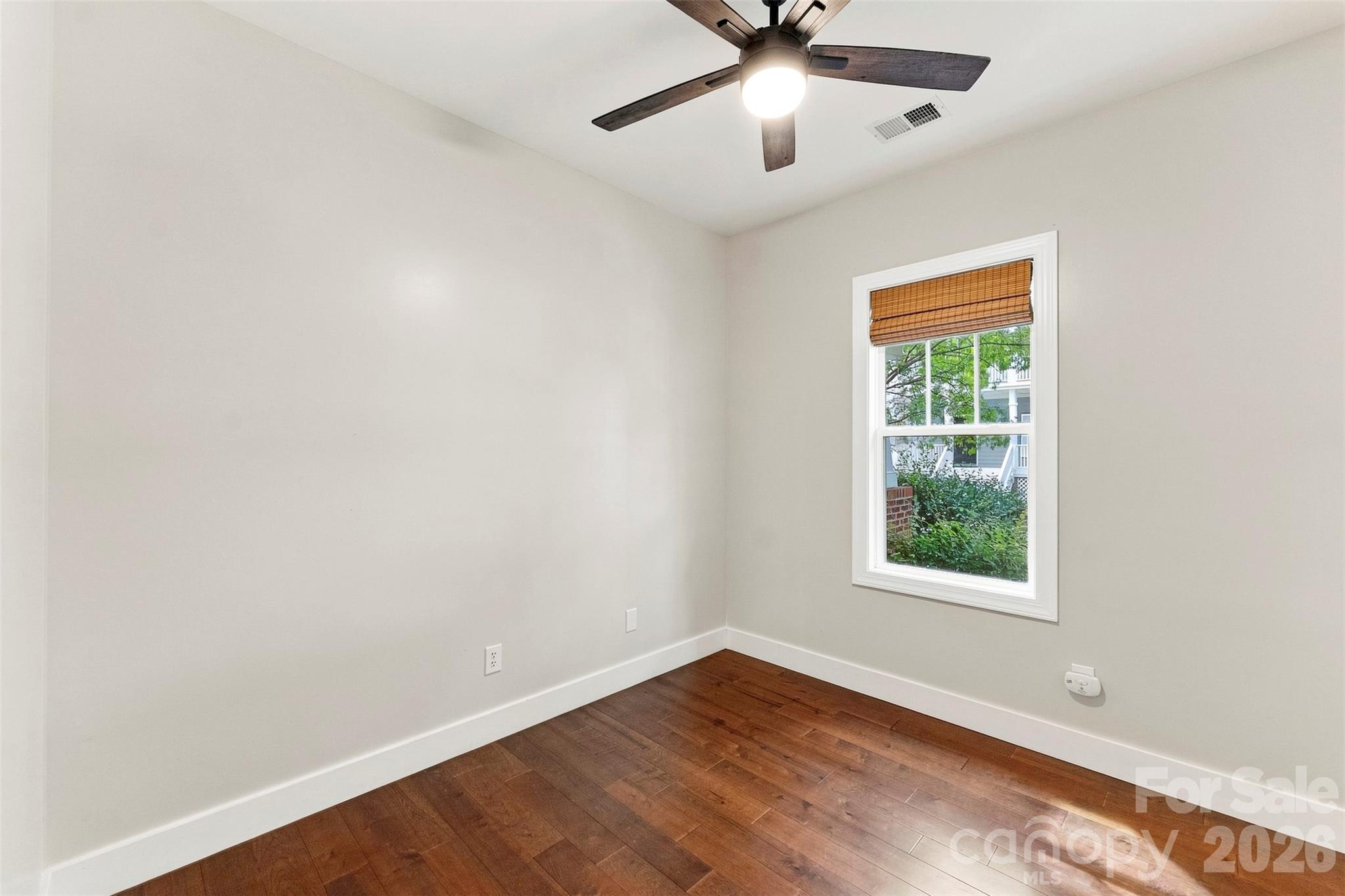 Secondary bedroom with hardwood flooring - 14100 Garden District Row, Huntersville
