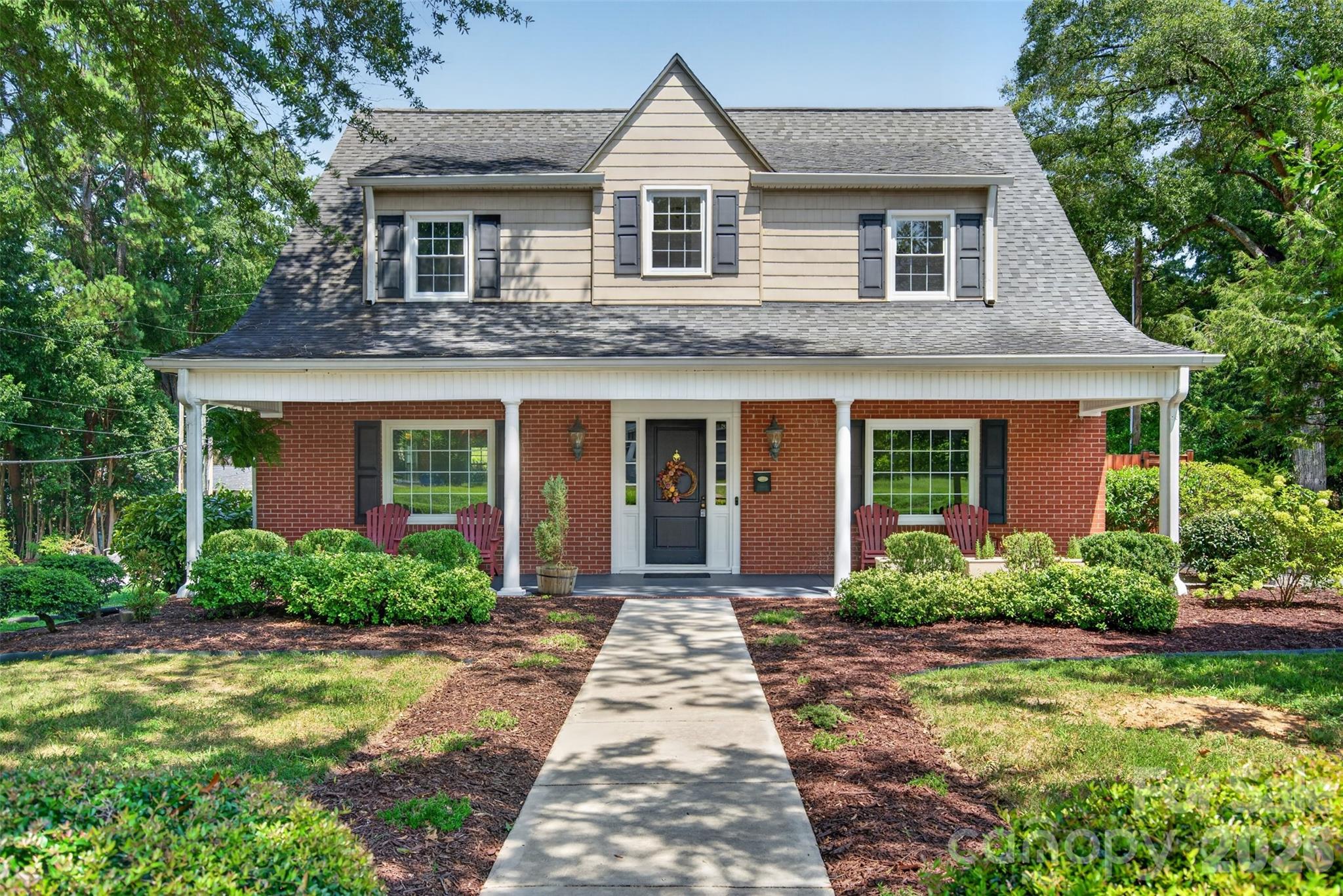 Charming Cape Cod style brick home with welcoming covered front porch, mature landscaping and classic architectural details. - 638 Carolina Avenue, Gastonia