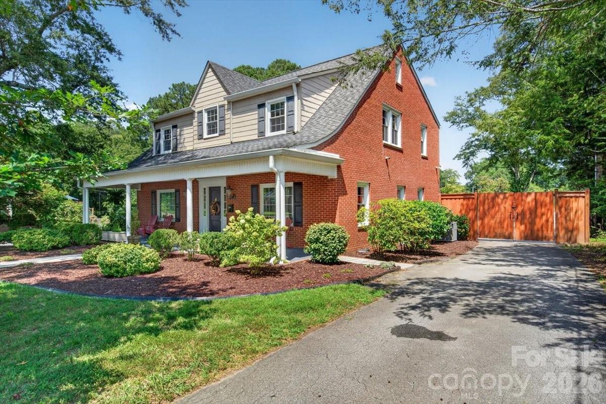 A side driveway leads to the private backyard, where an outdoor oasis awaits. - 638 Carolina Avenue, Gastonia