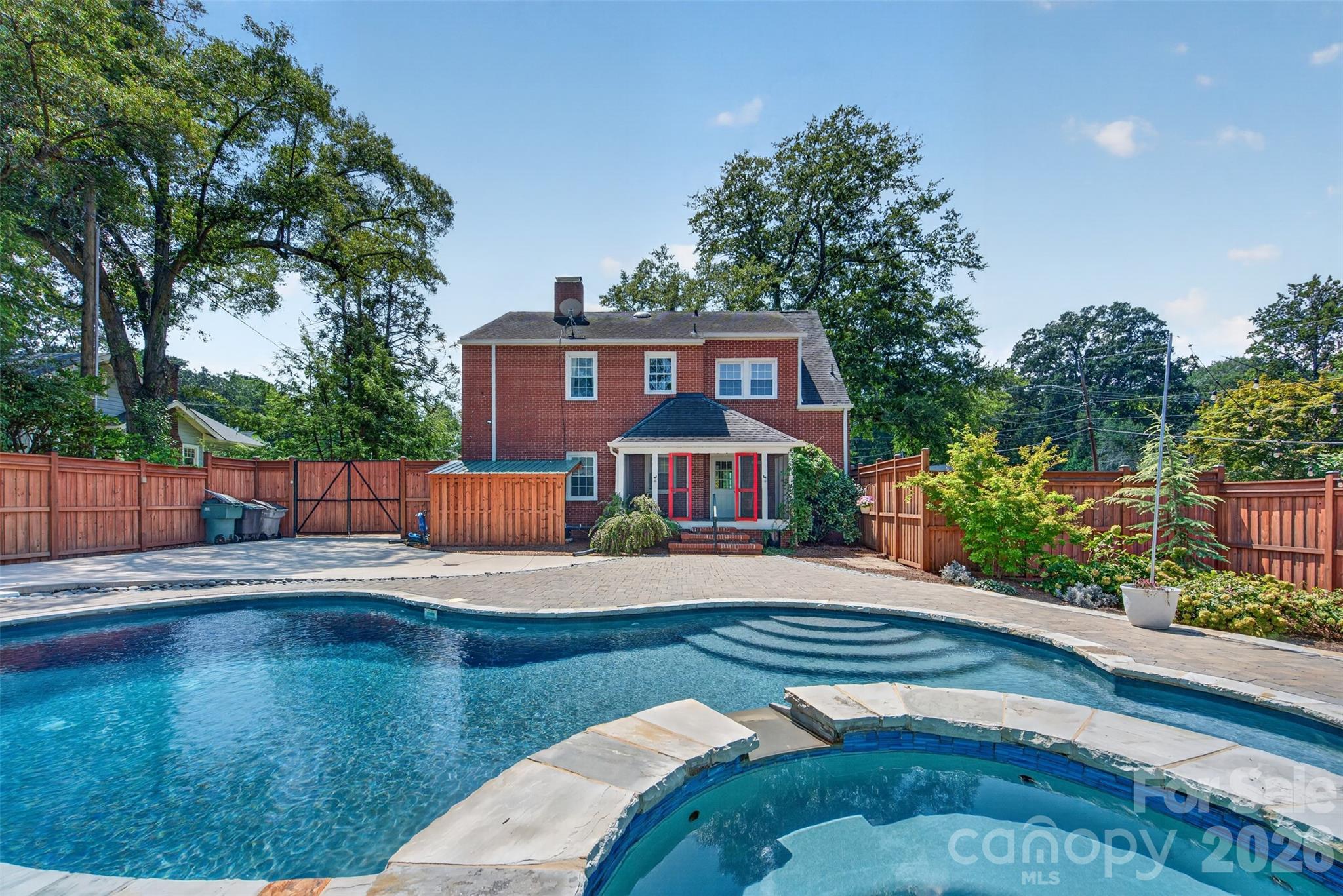 A first look at the backyard oasis featuring a lit, heated pool and hot tub surrounded by generous outdoor living space. And there's much more to see. - 638 Carolina Avenue, Gastonia
