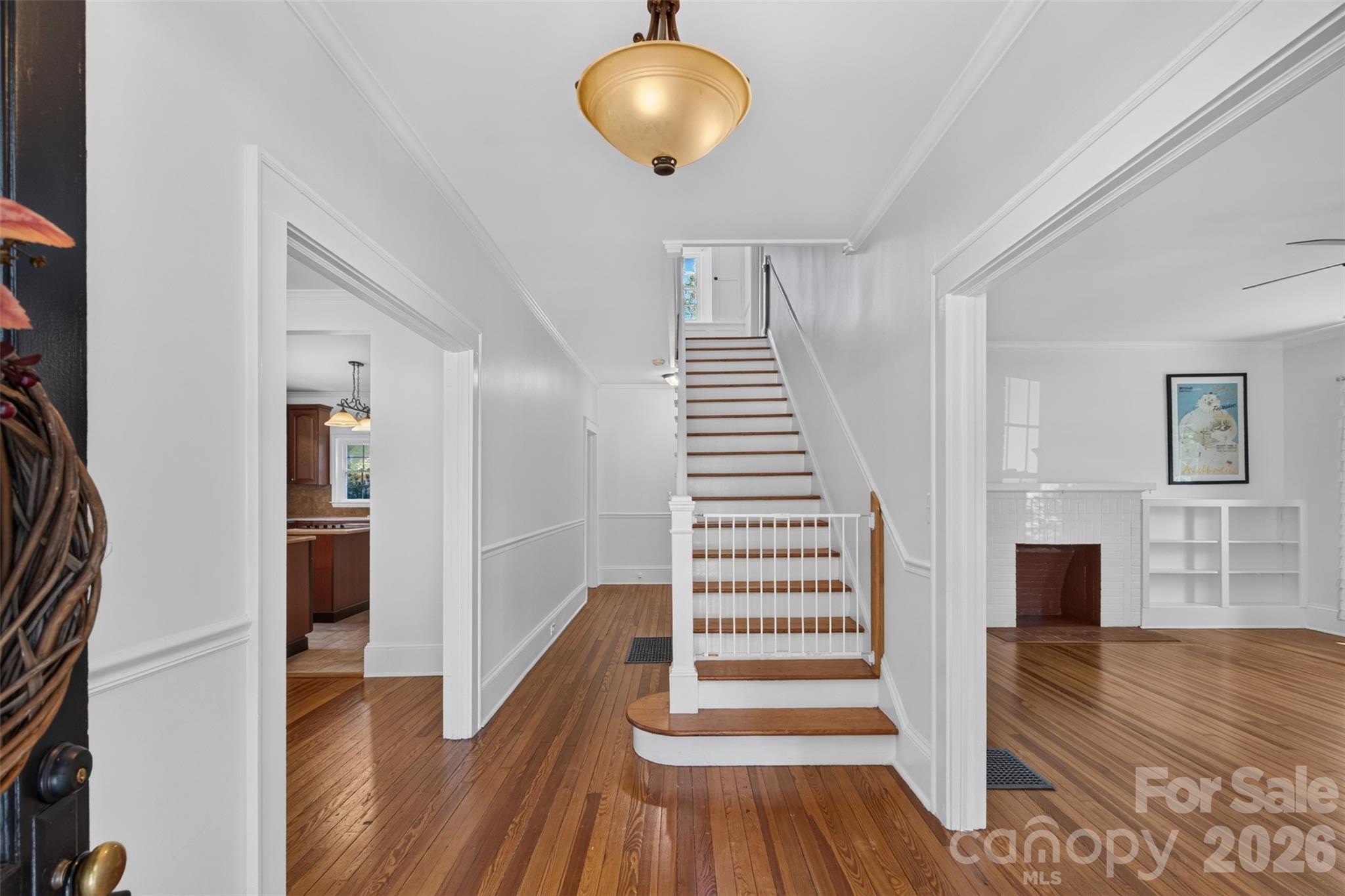 A bright, welcoming foyer showcases hardwood floors and classic architectural details. - 638 Carolina Avenue, Gastonia