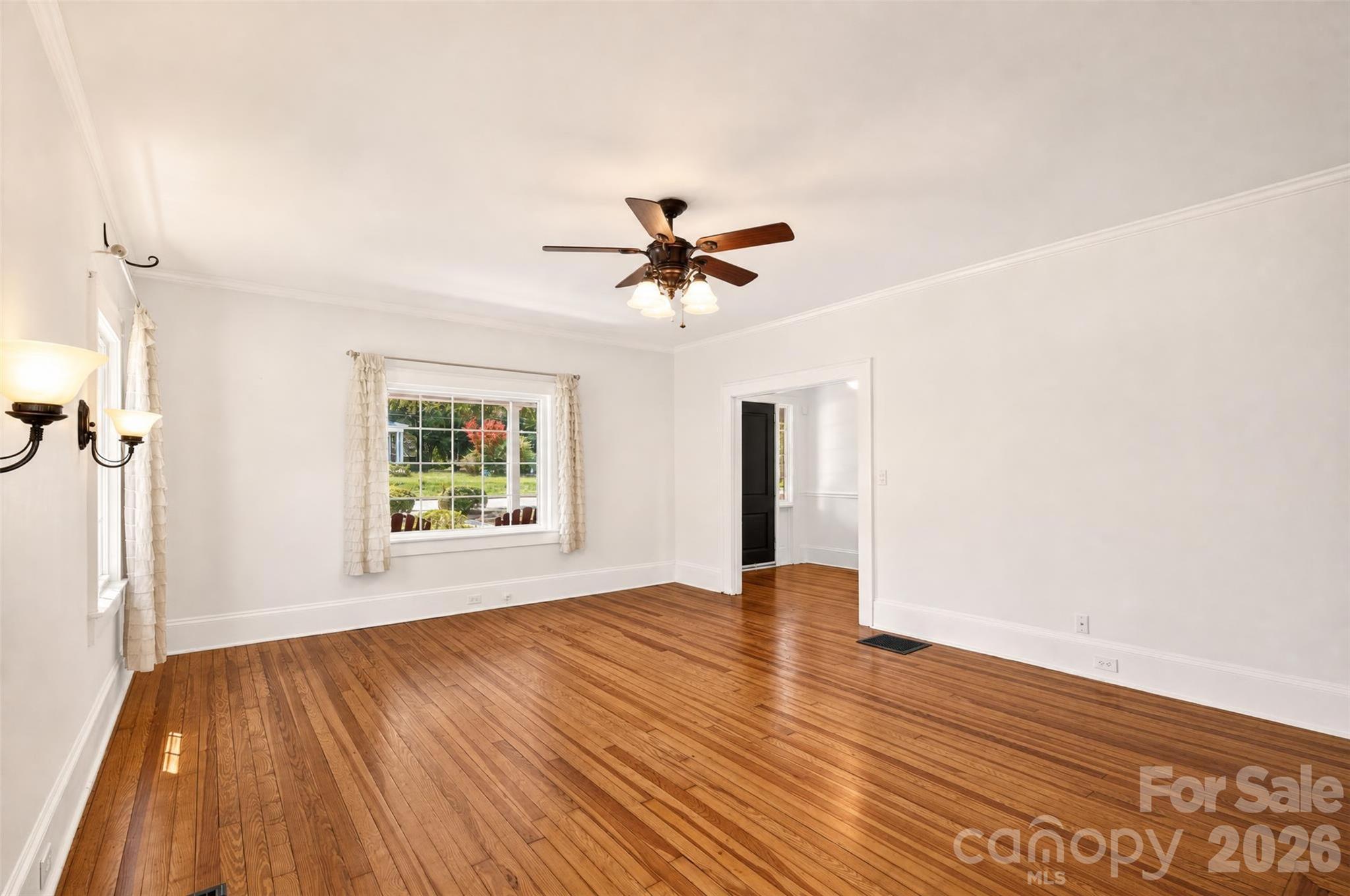 A large picture window fills the living room with natural light and provides a view of the covered front porch and lawn. - 638 Carolina Avenue, Gastonia