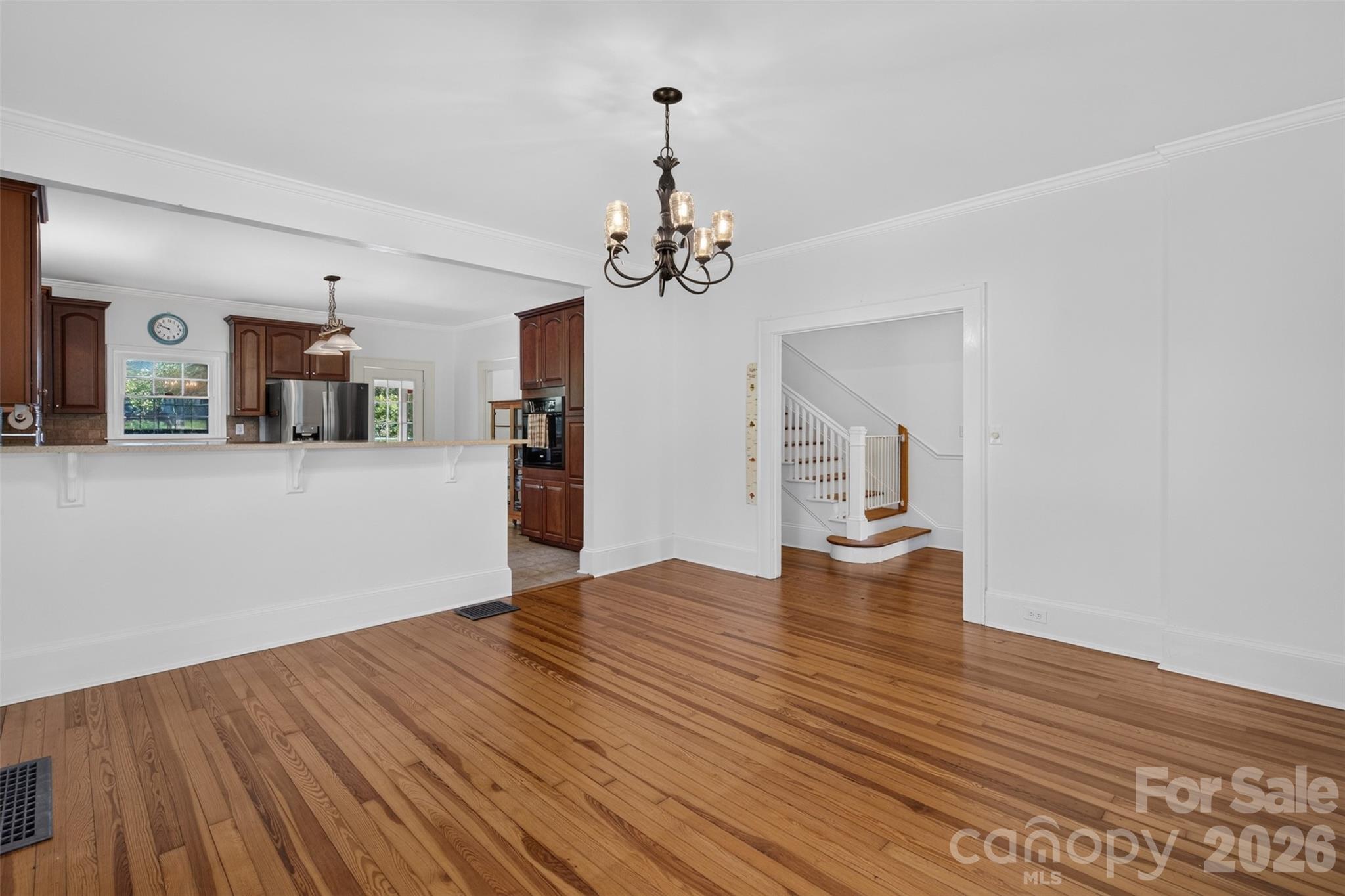The dining area connects easily with the kitchen, while hardwood floors and a chandelier add warmth and character. - 638 Carolina Avenue, Gastonia