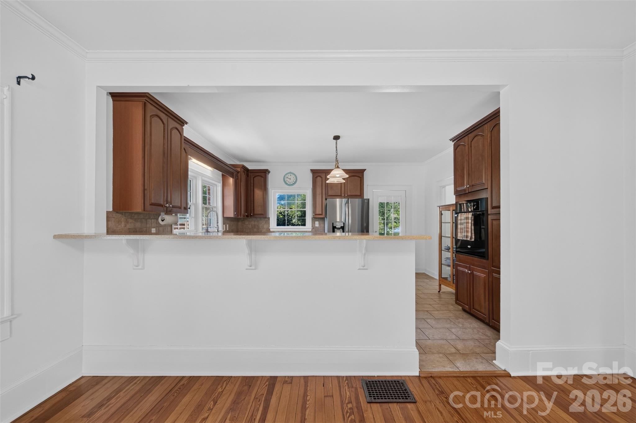 The kitchen opens to the dining room with a bar-top counter providing additional seating and serving space. - 638 Carolina Avenue, Gastonia