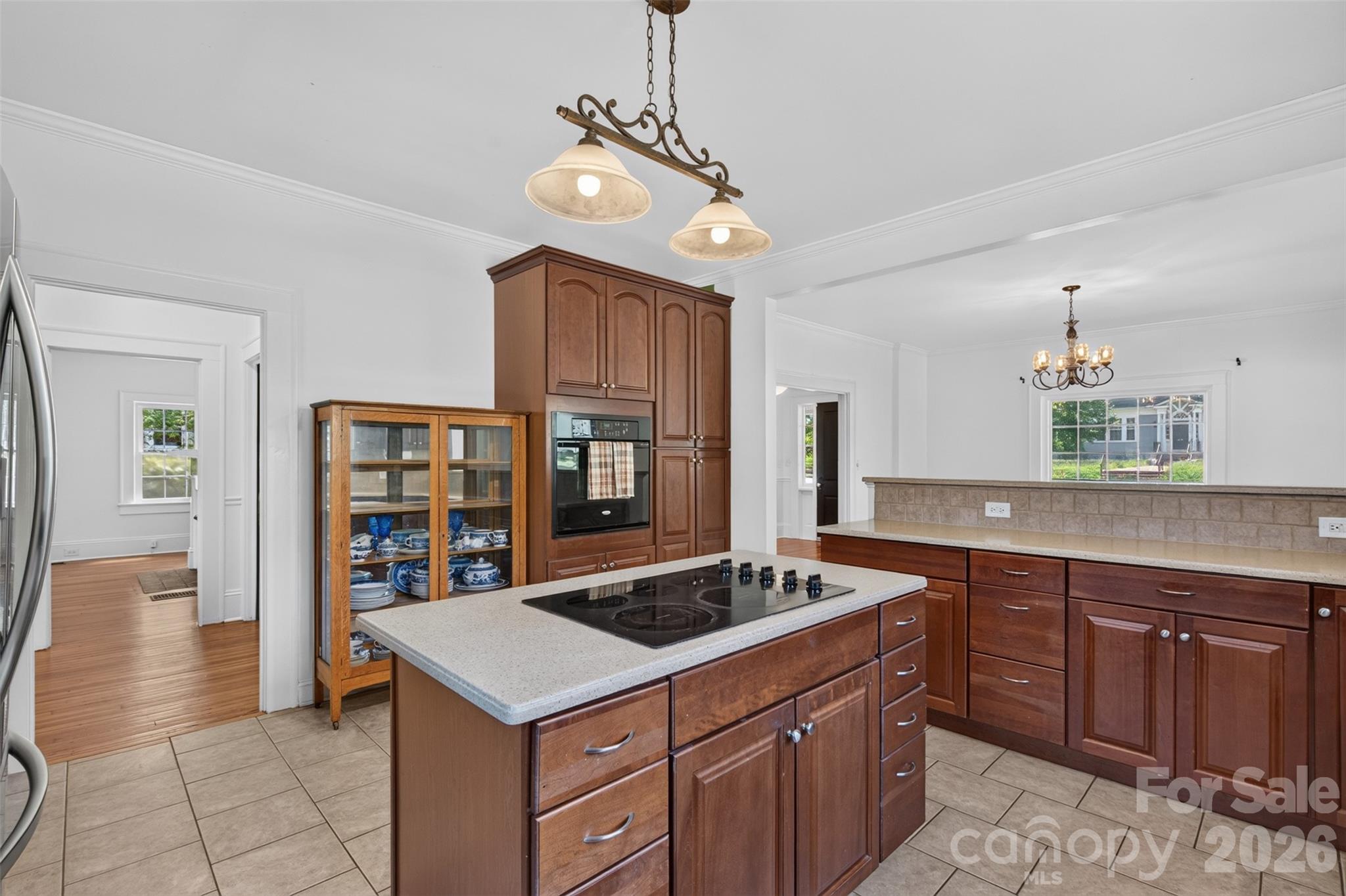 A closer look at the kitchen highlights the center island with abundant cabinetry and expansive counter space for prep and serving. - 638 Carolina Avenue, Gastonia