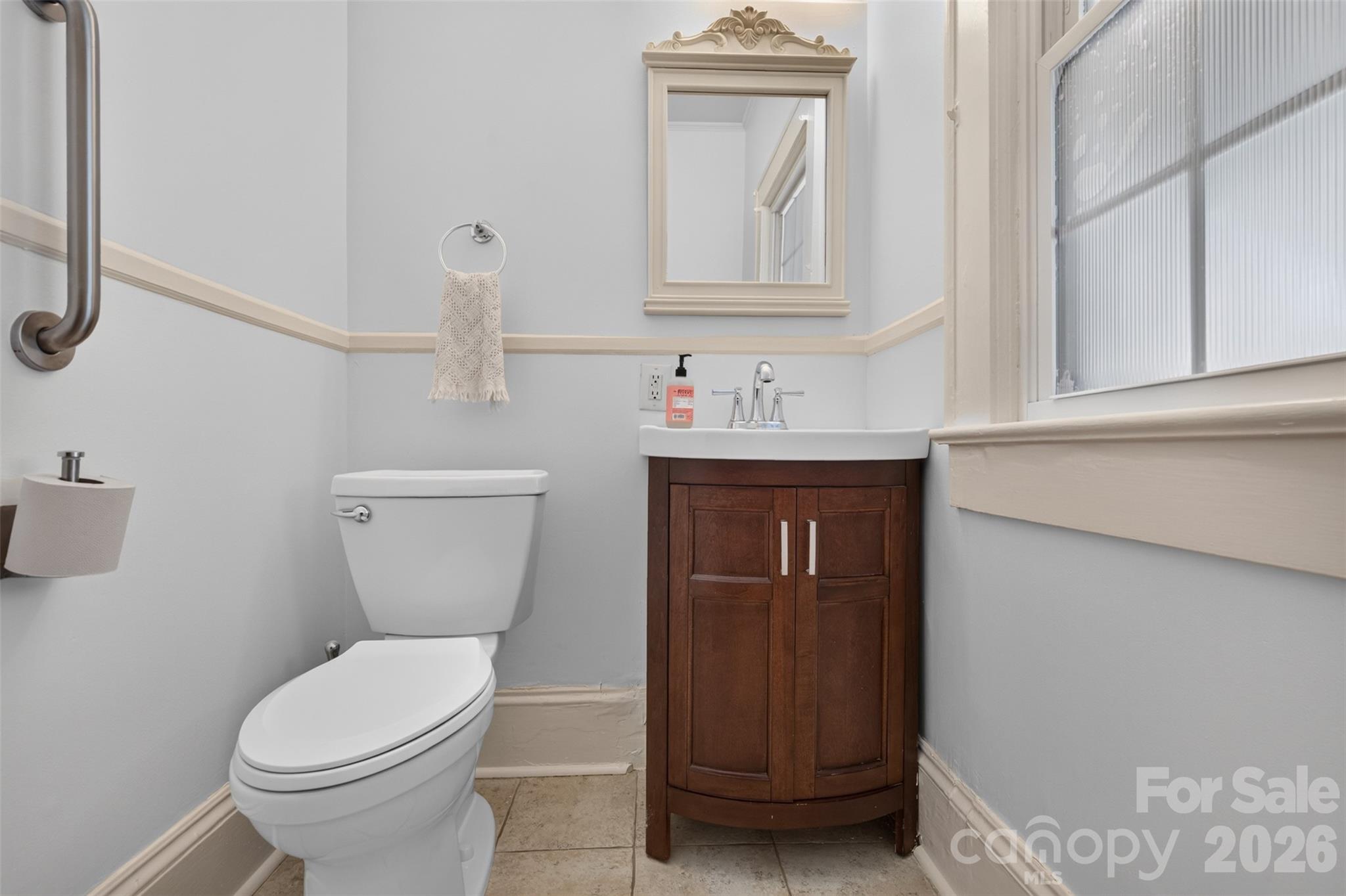 Convenient main-level powder room with a vanity and natural light. - 638 Carolina Avenue, Gastonia
