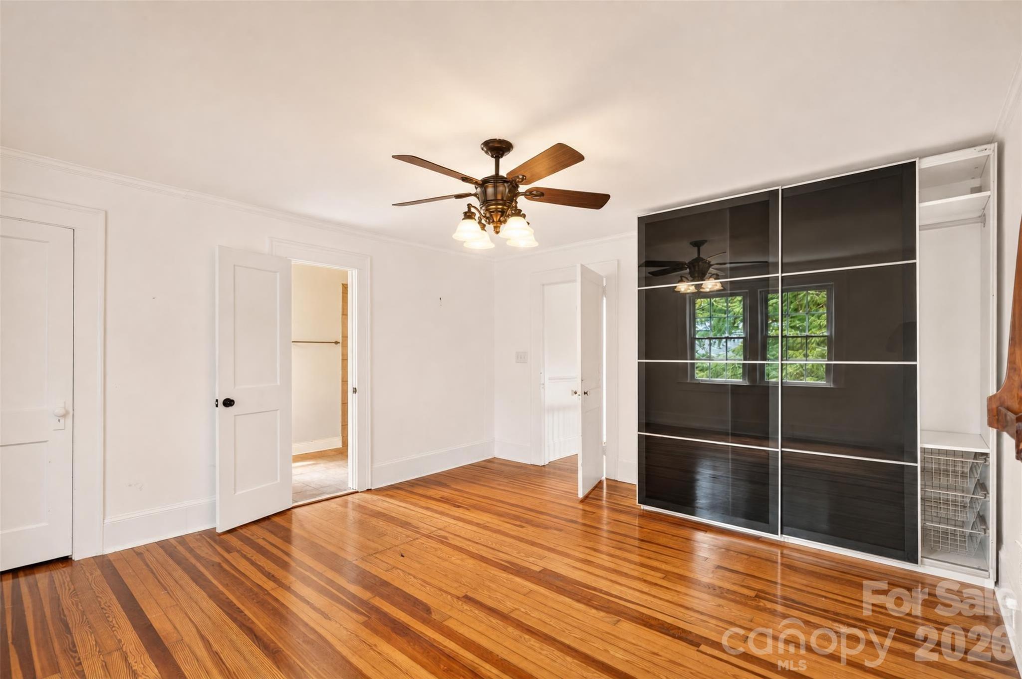 Another view of the primary bedroom shows the room's generous proportions along with a closet and direct access to the primary ensuite bath. - 638 Carolina Avenue, Gastonia