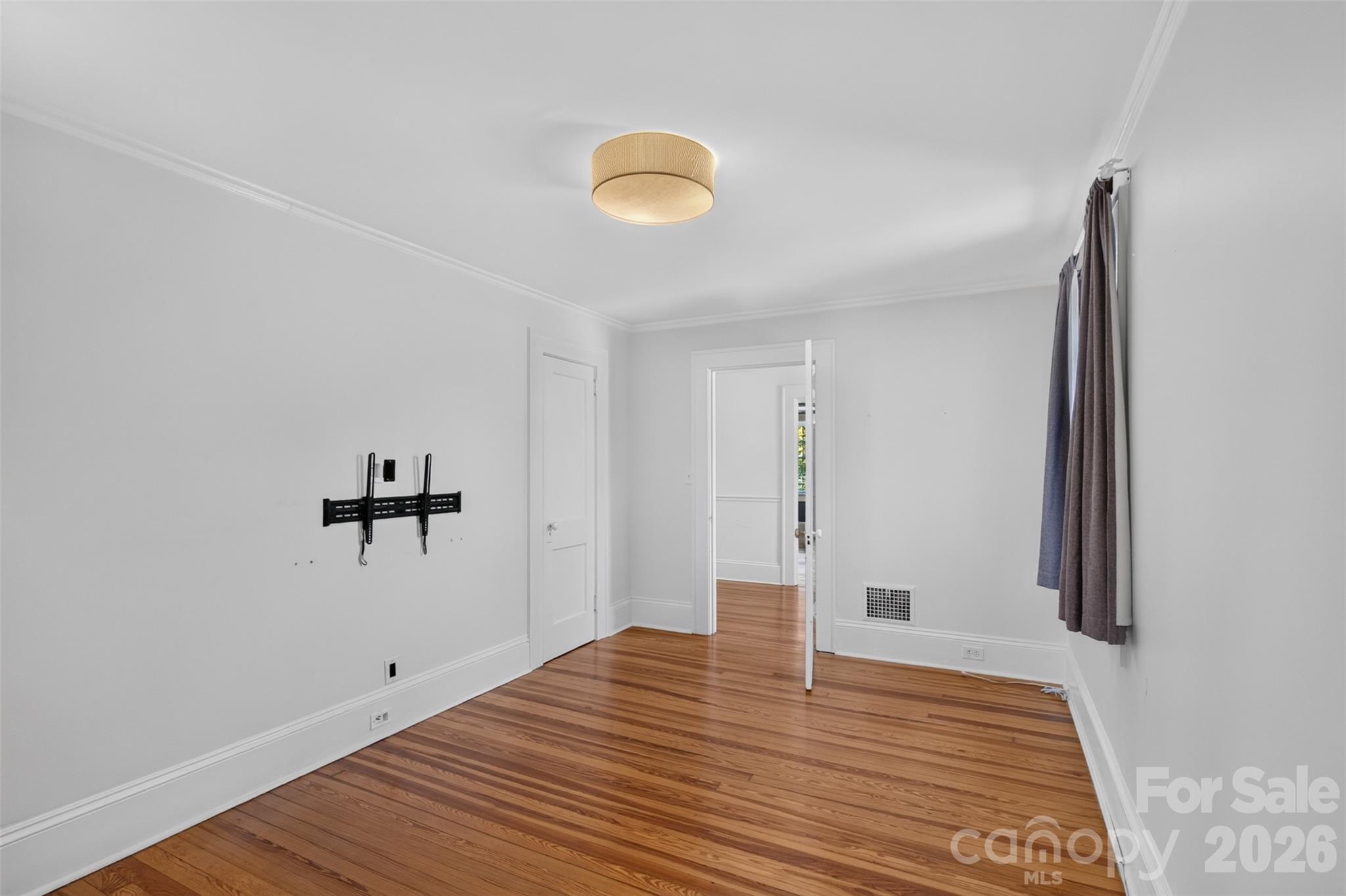 Another view of bedroom 2 shows the closet, hardwood floors, and ample wall space for furniture placement. - 638 Carolina Avenue, Gastonia