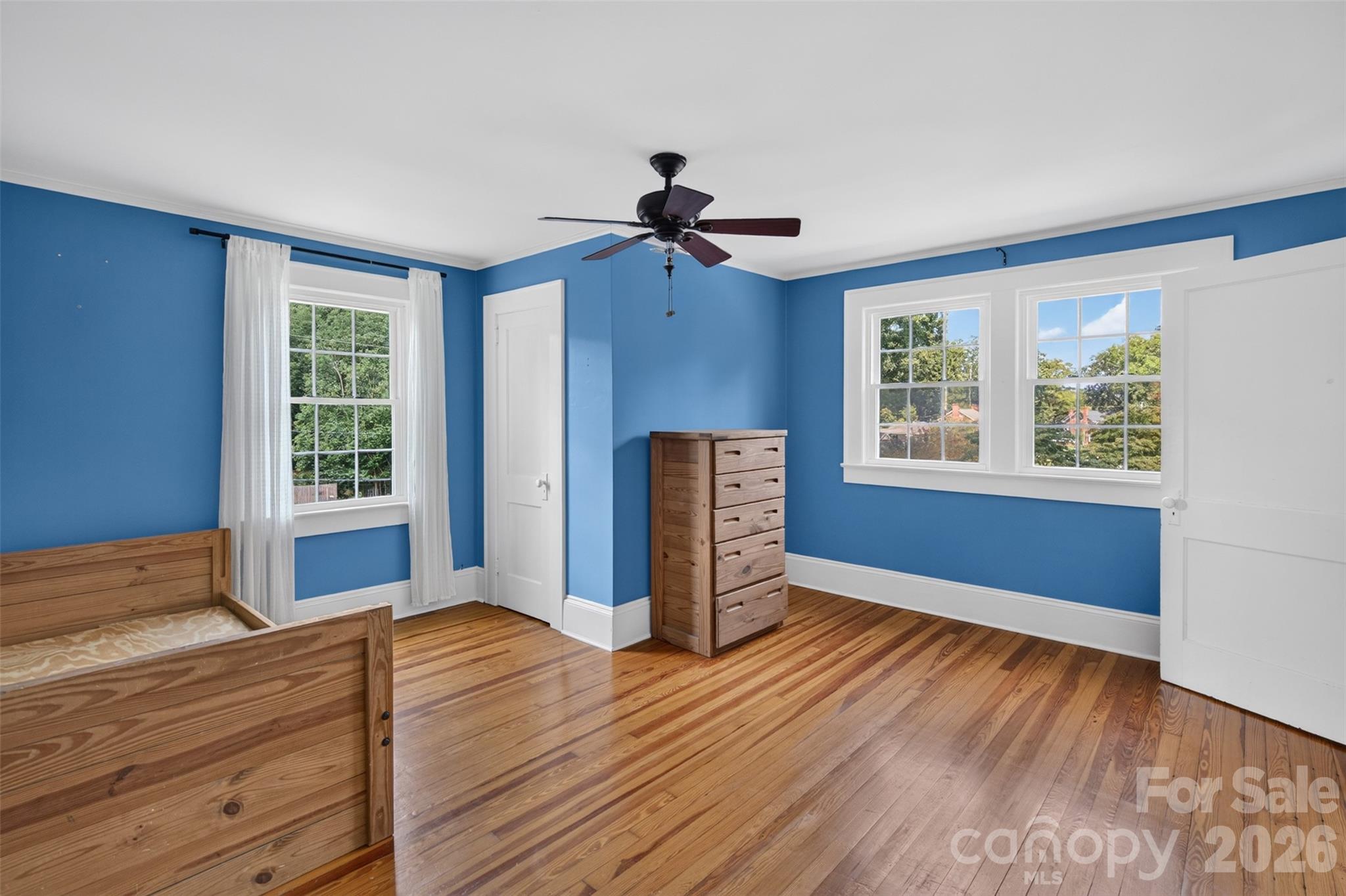 Generously sized bedroom 3 has hardwood floors, multiple windows for natural light, and plenty of room for a variety of furniture arrangements. - 638 Carolina Avenue, Gastonia