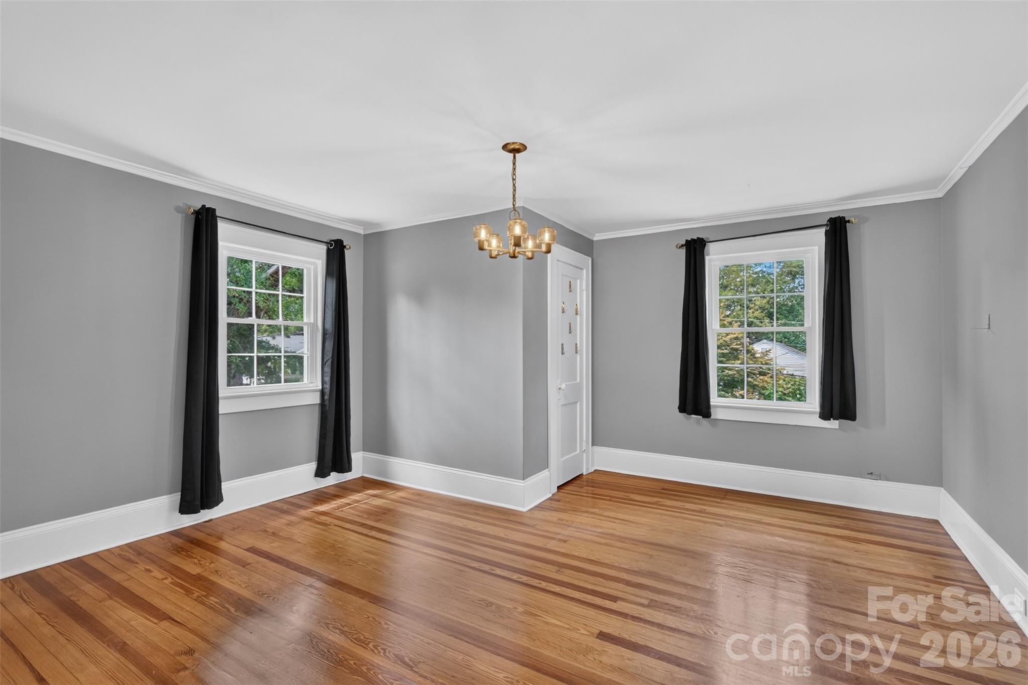 The windows bring natural light into bedroom 4 while the angled walls and architectural details give the room added character. - 638 Carolina Avenue, Gastonia