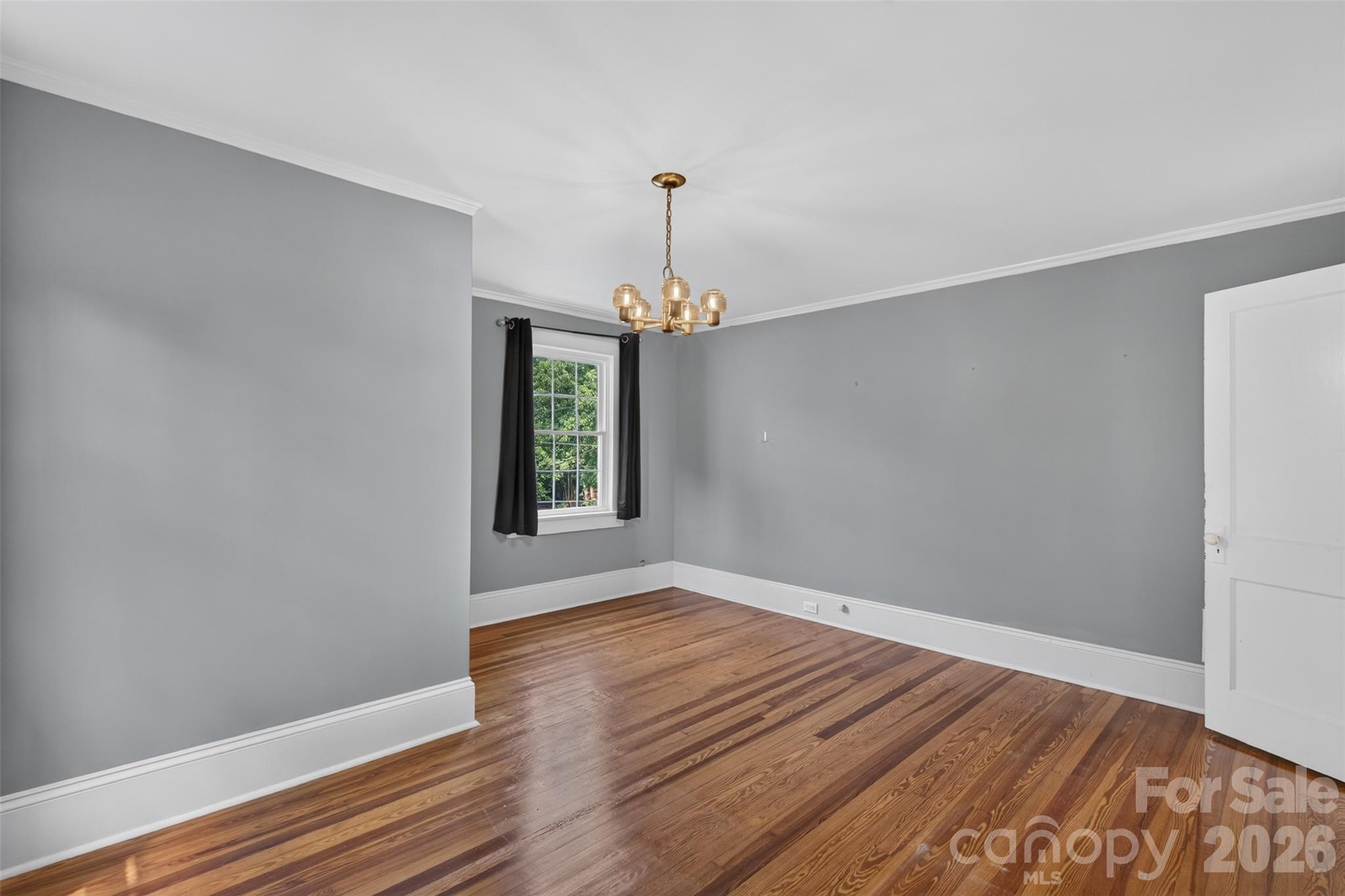 Bedroom 4 offers generous floor space, hardwood floors, crown molding, and plenty of flexibility for furniture placement. - 638 Carolina Avenue, Gastonia