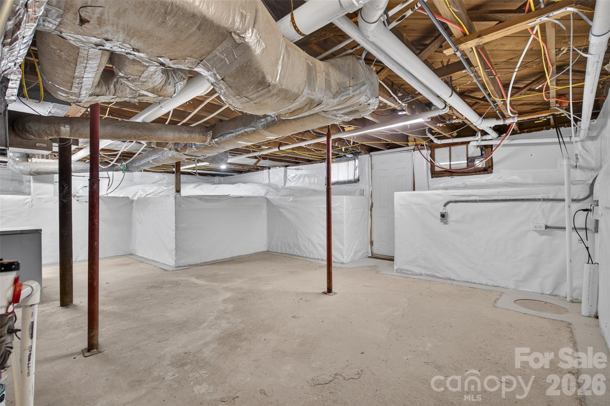 Basement area with laundry connections, encapsulation completed and sump pump installed in 2026, providing additional utility and storage space. - 638 Carolina Avenue, Gastonia