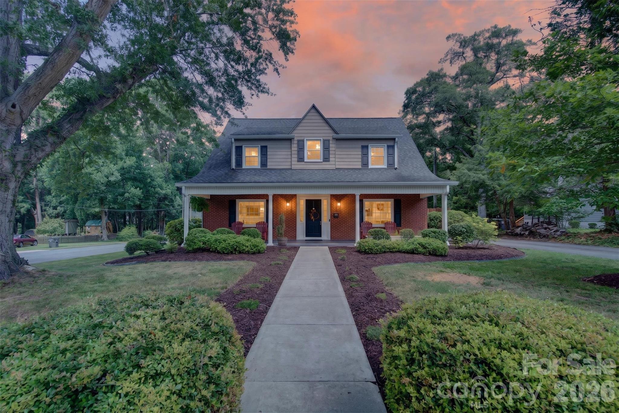 As evening settles in, the home takes on an inviting glow, a fitting final look at a property filled with character, warmth, and spaces designed to be enjoyed inside and out. (Image digitally enhanced to depict twilight conditions.) - 638 Carolina Avenue, Gastonia
