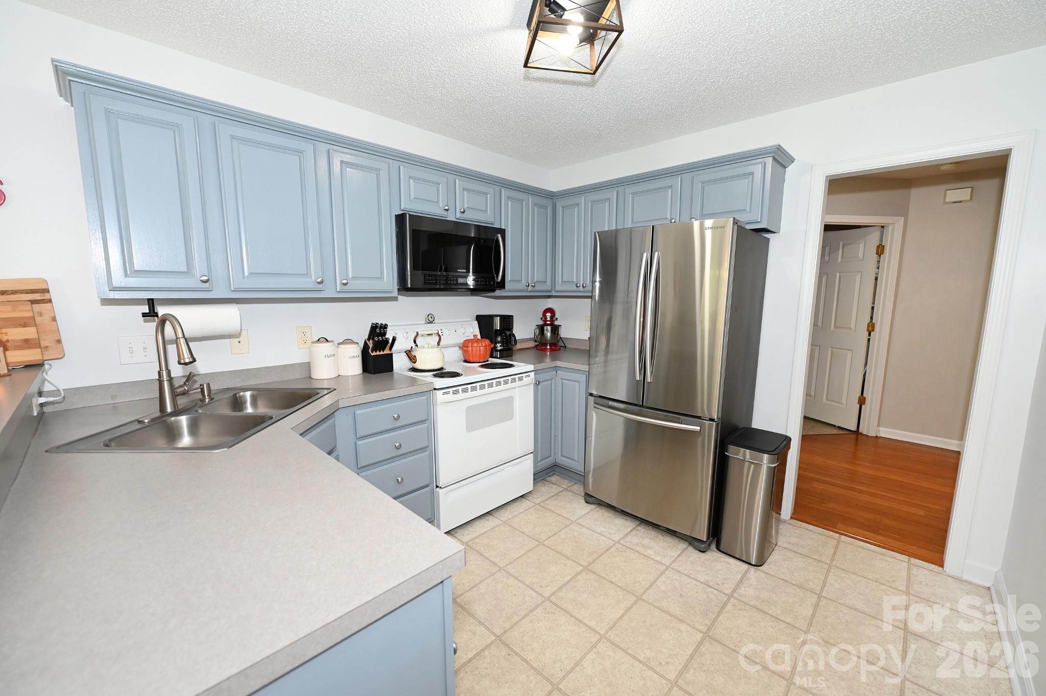 Kitchen with doorway to the half bath and laundry room - 236 17th Avenue SE, Hickory
