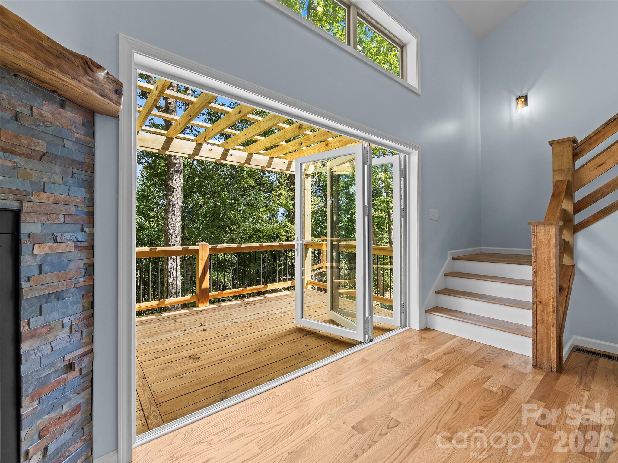 Whole wall accordion door to invite the nature in. - 214 Aster Ridge Drive, Waynesville