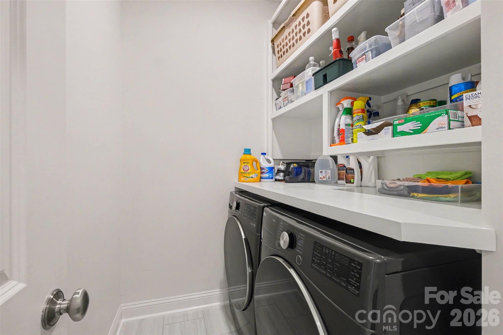 The laundry room - on the same level as bedrooms - includes a folding counter and shelves for extra organization! - 3743 Keyworth Way, Indian Land