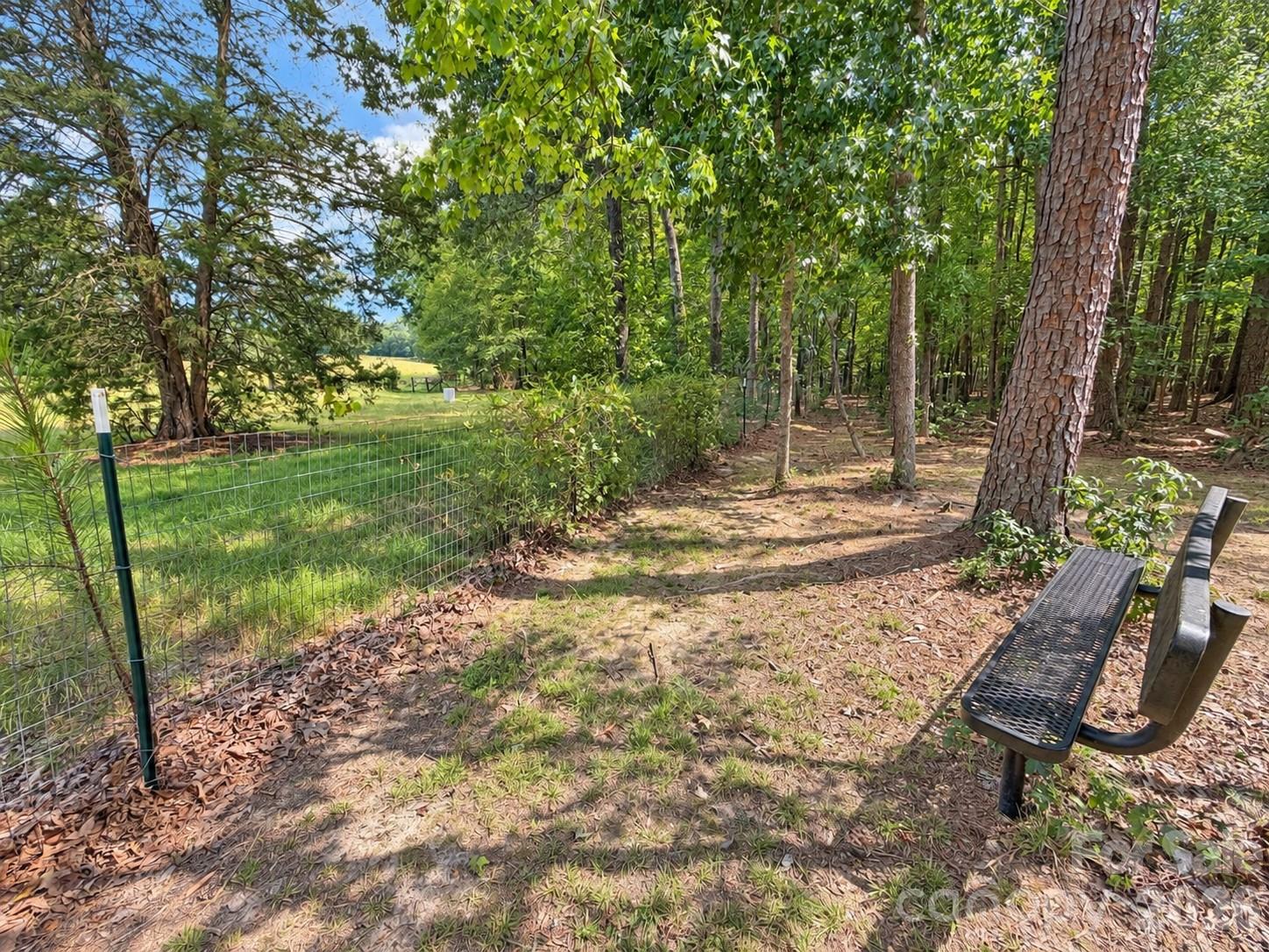 bench at the back of the property for sitting to watch the neighboring farm animals - 9201 Providence Road S, Waxhaw