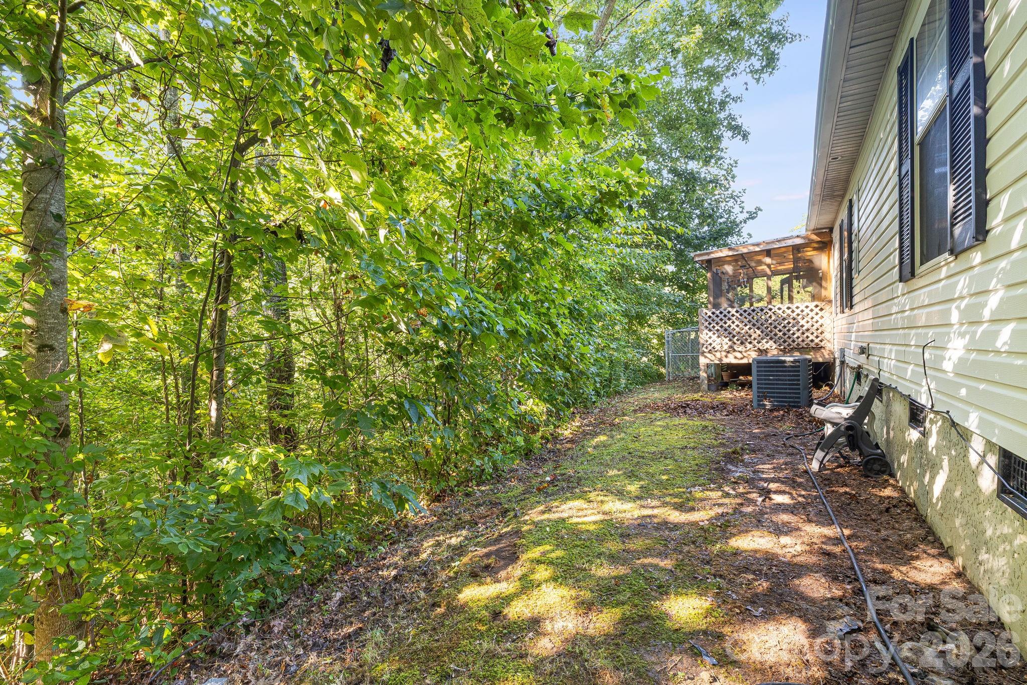 Left side backyard. - 96 Fallswood Court, Hendersonville