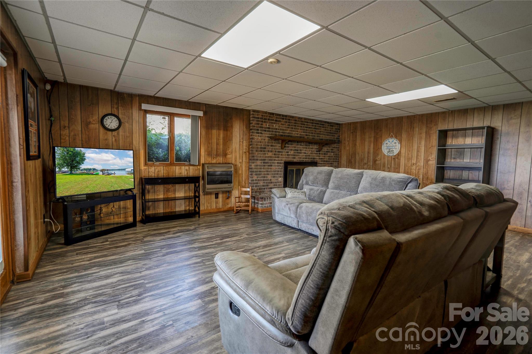 Basement family room features a fireplace and gas space heater - 152 North Shore Drive, Cherryville