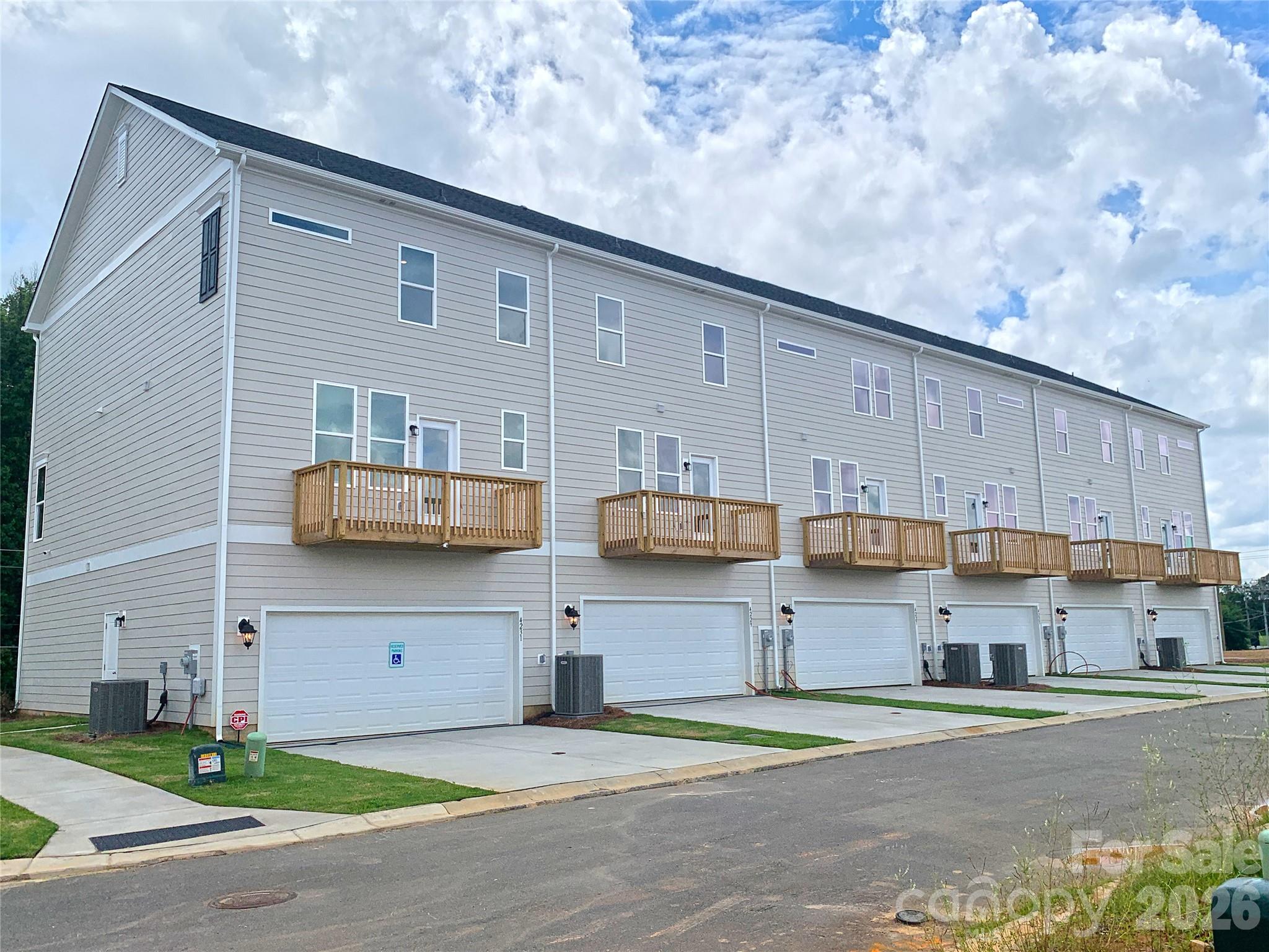 Rear elevation and garage view of 3-story townhomes - 4219 S New Hope Road, Gastonia