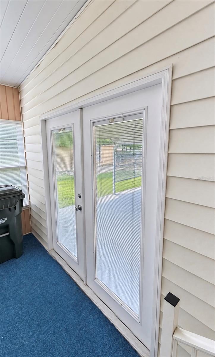 French doors to side enclosed lanai - 1100 BELCHER RD S #535, LARGO