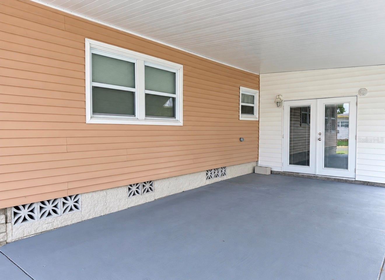 Side fronch doors to enclosed lanai - 1100 BELCHER RD S #535, LARGO