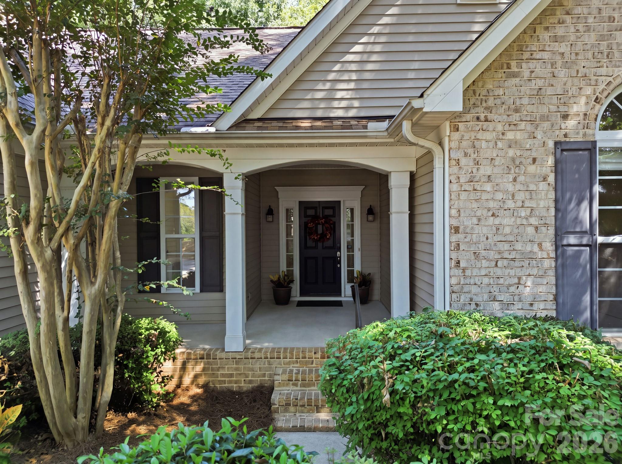 Front entrance of the home, showcasing the main entryway and exterior facade. - 14724 Beatties Ford Road, Huntersville