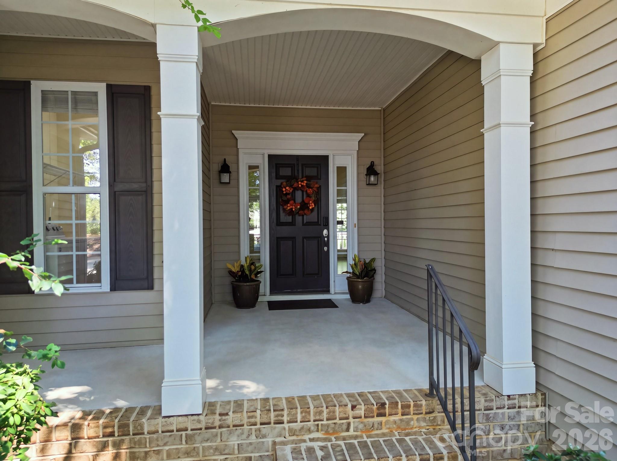 Stunning front entrance featuring professional landscaping and a welcoming entryway. - 14724 Beatties Ford Road, Huntersville