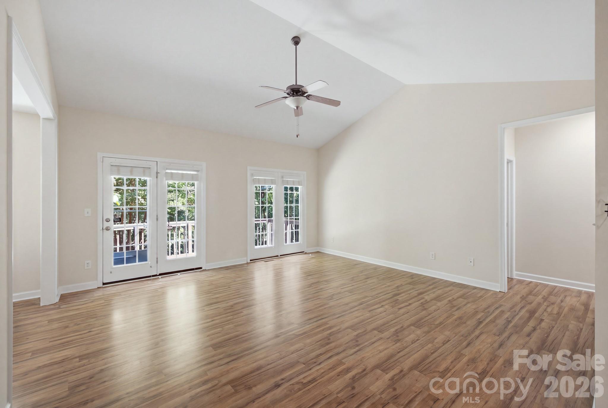 Living room featuring a spacious great room with vaulted ceilings. - 14724 Beatties Ford Road, Huntersville