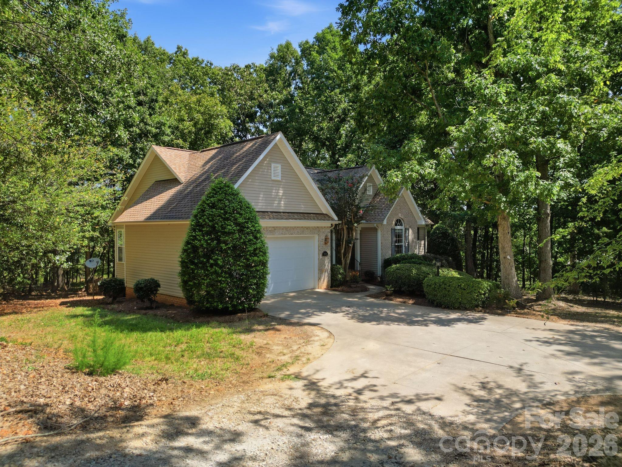 Front exterior view showcasing the driveway and main entrance. - 14724 Beatties Ford Road, Huntersville