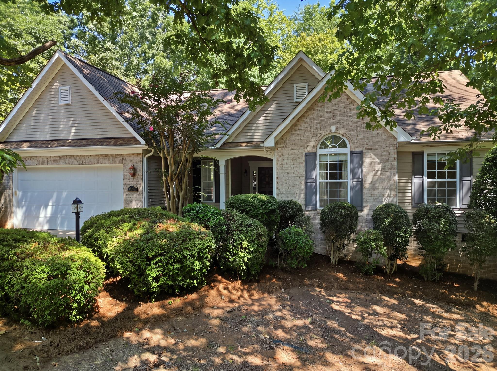 Beautifully landscaped front exterior of the home with professional curb appeal. - 14724 Beatties Ford Road, Huntersville